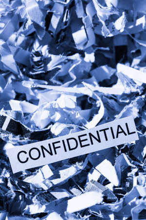 shredded paper tagged confidential, symbol photo for data destruction, bank secrecy and confidentialityの写真素材