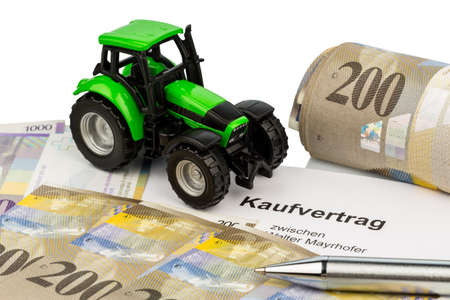 the agreement to purchase a new tractor with a swiss car dealer  with swiss francs の写真素材