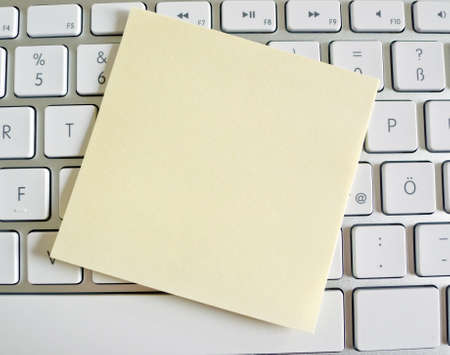 a memo is on the keyboard of a computer as a reminder  emptyの写真素材