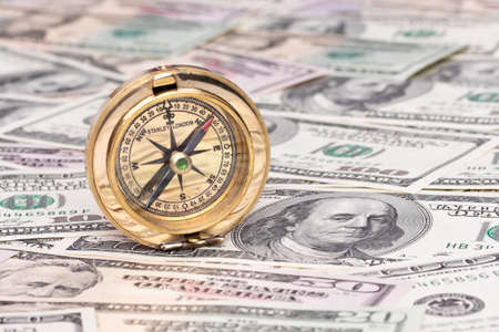 many dollar bills and compassの写真素材
