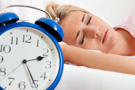 insomnia with clock in the night  woman can not sleep の写真素材