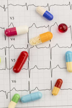 several tablets are on an ekg  symbolic for diseases of the cardiovascular system