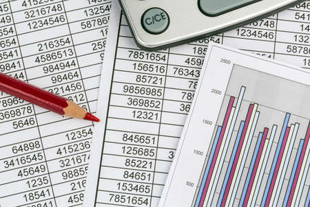 a calculator is on a balance sheet numbers are statistics  photo icon for sales, profit and cost 