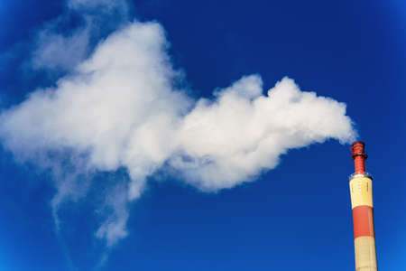 chimney of an industrial company with smoke  symbolic photo for environmental protection and ozone 