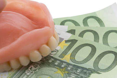 denture and euro notes, symbolic photo for dentures, treatment costs and paymentの写真素材
