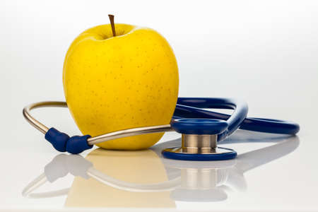 a stethoscope and an apple  symbolic of healthy eating の写真素材