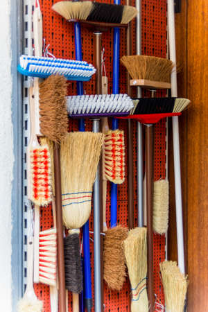 cabinet with different types of brooms