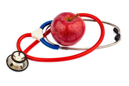 an apple and a stethoscope with a doctor  representative of healthy and vitamin-rich diet の写真素材