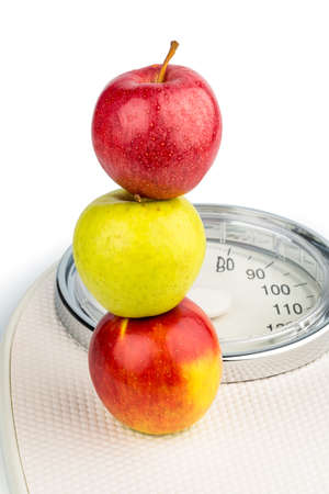 several apples on a balance of people  symbolic photo for diet and healthy, vitamin-rich diet の写真素材