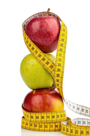several apples with a tape measure  symbolic photo for diet and healthy, vitamin-rich diet の写真素材