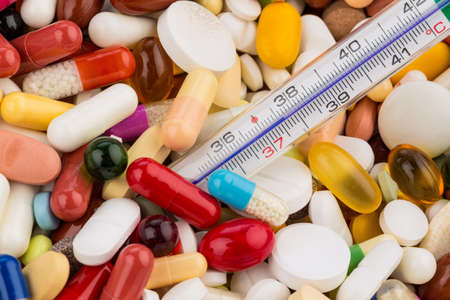 thermometer and tablets, symbolic photo for disease and medication