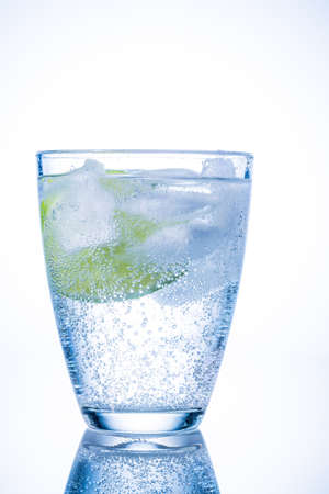 a glass of fresh drinking water and a lime  mineral water as a thirst quencher の写真素材