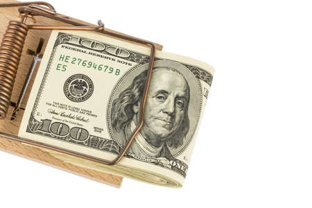 dollar banknotes in a mousetrap  symbolic photo for debtの写真素材