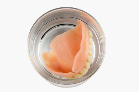 denture m water glass, symbolic photo for dentures and careの写真素材