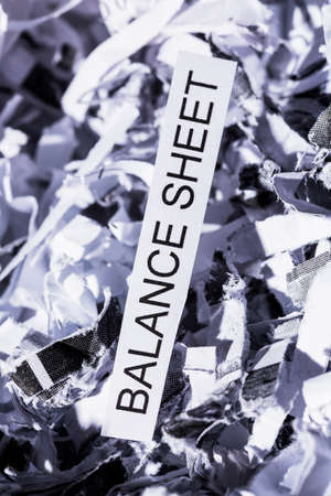 shredded paper tagged with balance sheet, symbol photo for data destruction, budgets and accountingの写真素材