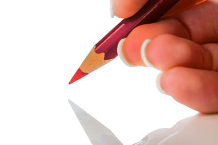 a hand holding a red pen