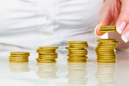a woman stacks coinsの写真素材