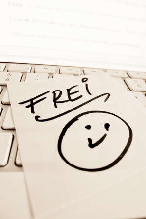 a sticky note on the keyboard of a computer wrote freeの写真素材