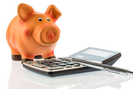 a pen is on a calculator beside a piggy bank