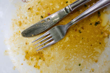 a cutlery is after the food on a plateの写真素材