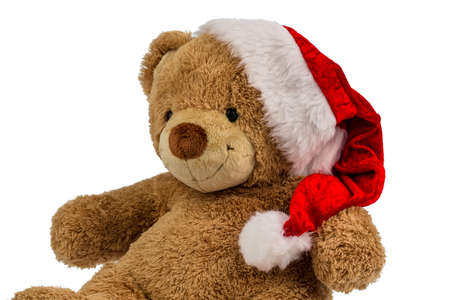 a teddy bear with gifts for christmas. dressed as santa claus.の写真素材