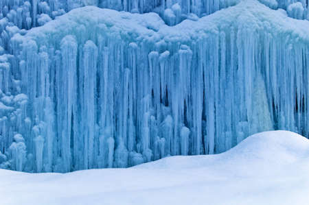 a frozen by the cold waterfall. icy waterfall in winter.の写真素材