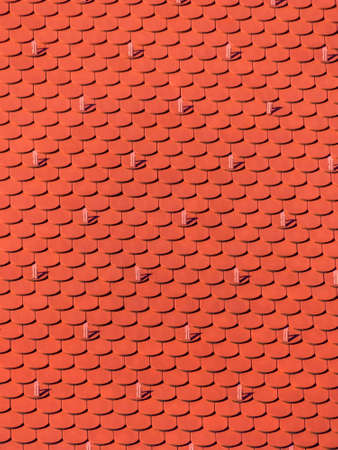 the roof of an old building (church) has been newly renovated. new tiles on houseの写真素材