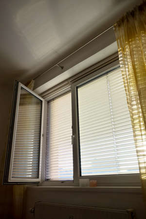 to protect against heat and sun blinds are attached to a window.