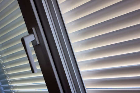 to protect against heat and sun blinds are attached to a window.の写真素材