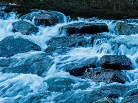 a creek with rocks and running water. landscape experience in nature.の写真素材