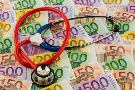 stethoscope and euro bills. symbolic photo for healthcare costs and for health and medicineの写真素材