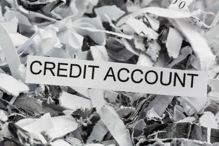 shredded paper tagged with credit account, symbolic photo for data destruction, finance and creditの写真素材