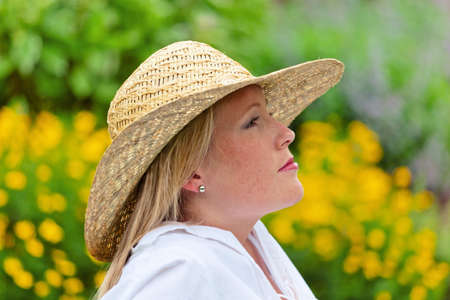 a young woman sits at rest in the meadow  lunch in the park の写真素材