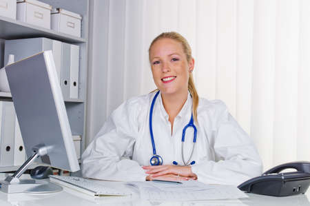 a young doctor with stethoscope in her doctor s office の写真素材