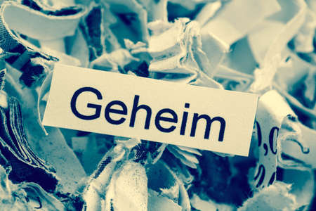 shredded paper tagged with secret, symbol photo for data destruction, secrecy and economic espionageの写真素材