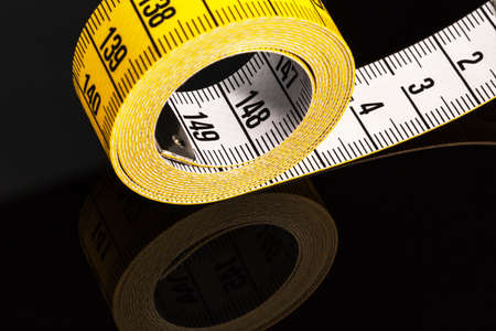 yellow tape measure, symbolic photo for diet control and precisionの写真素材