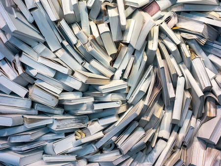 many books are completely messed up on a pile