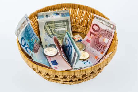 a basket of money for donations and gratuitiesの写真素材