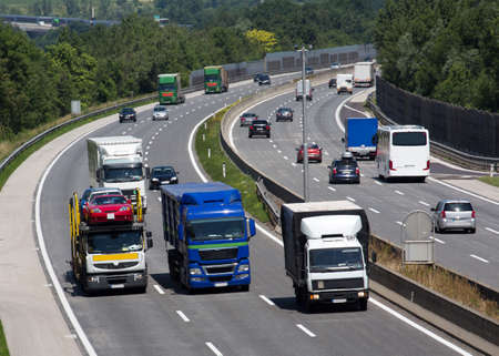 trucks on a three-lane motorway. symbolic photo for transport of goodsの写真素材