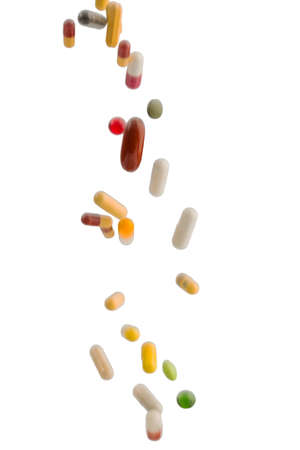 many colorful pills on a white background. symbolic photo for medicine and drugsの写真素材
