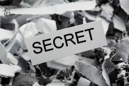 shredded paper tagged with secret, symbol photo for data destruction, banking secrecy and economic espionageの写真素材