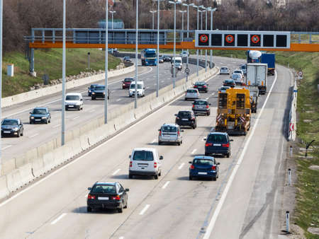cars on a highway with a speed limit icon photos of transport, mobility, environmental protectionの写真素材