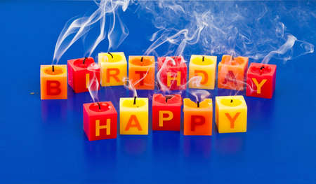 candles with the aqufschrift "happy birthday" at a birthday celebrationの写真素材
