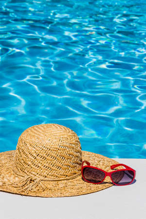 utensils for a nice and relaxing vacation day lying next to a swimming pool. relaxation on holiday.の写真素材