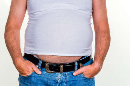 man with overweight. symbolic photo for beer belly, unsuccessful diets and poor diet.の写真素材