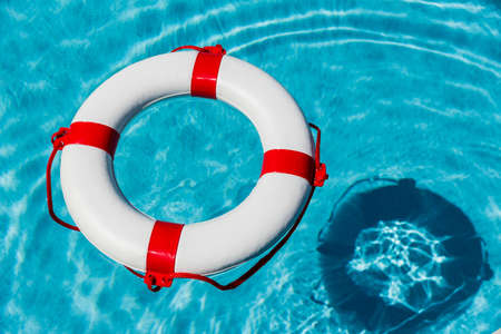 a rescue tire floating in a swimming pool. symbolic photo for rescue and crisis management in the...