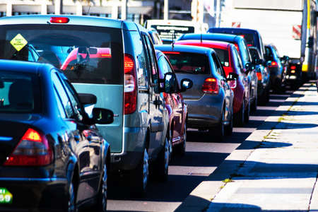in rush hour traffic cars jam on a road in the city center. problems in urban traffic in rush hour traffic cars jam on a road in the city center. problems in urban traffic