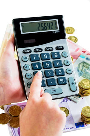 hand with calculator and bills. symbolic photo for turnover, profit, taxes and costingの写真素材