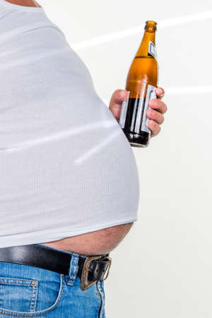 man with overweight. symbolic photo for beer belly, unsuccessful diets and poor diet.の写真素材