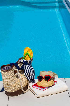 utensils for a nice and relaxing vacation day lying next to a swimming pool. relaxation on holiday.